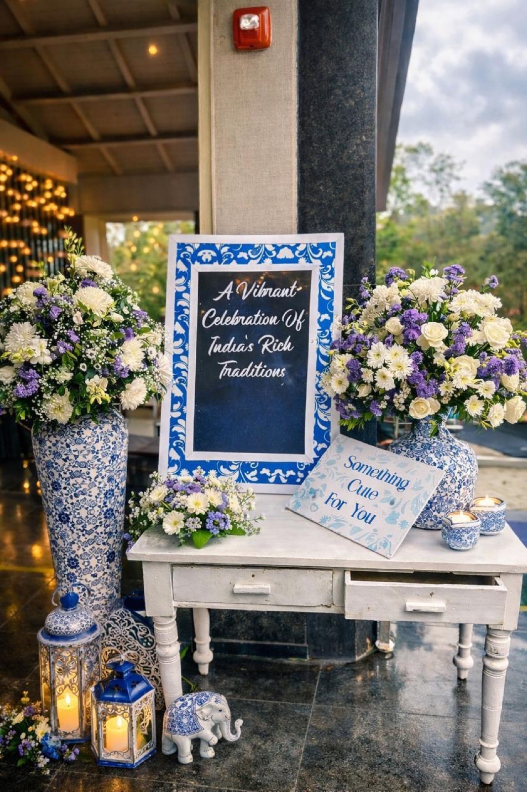 Blue-and-white welcome vignette with porcelain vases, lanterns and hand-lettered signage — Panigrahana decor