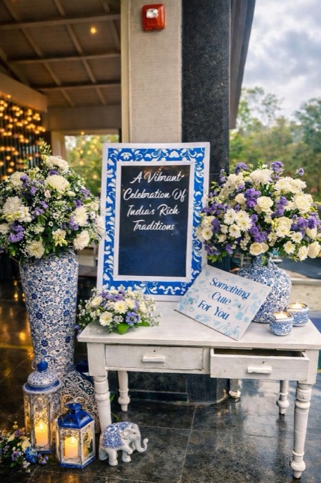 Blue-and-white welcome vignette with porcelain vases, lanterns and hand-lettered signage — Panigrahana decor