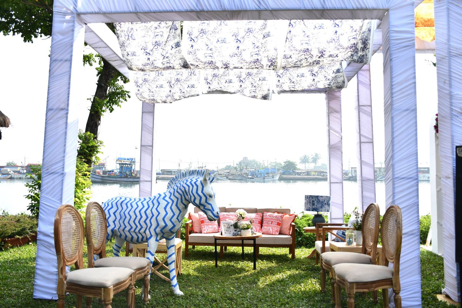 Blue and white pergola lounge with a carousel horse overlooking backwaters