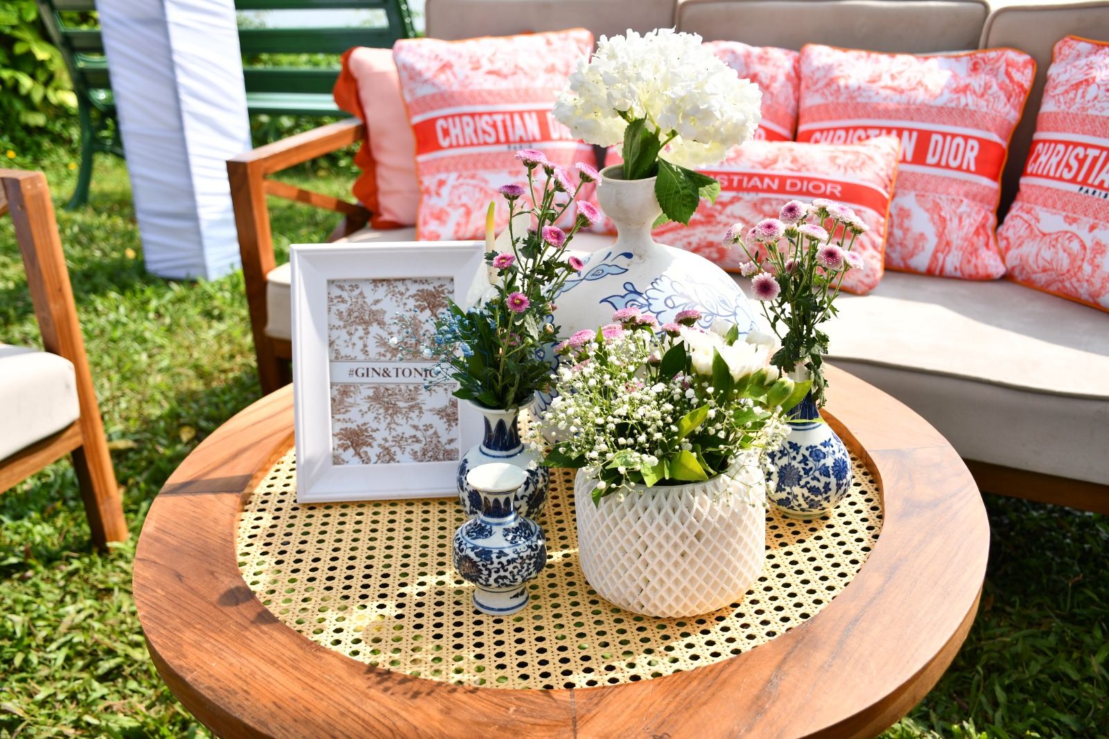 Chinoiserie garden table vignette with printed cushions and fresh florals