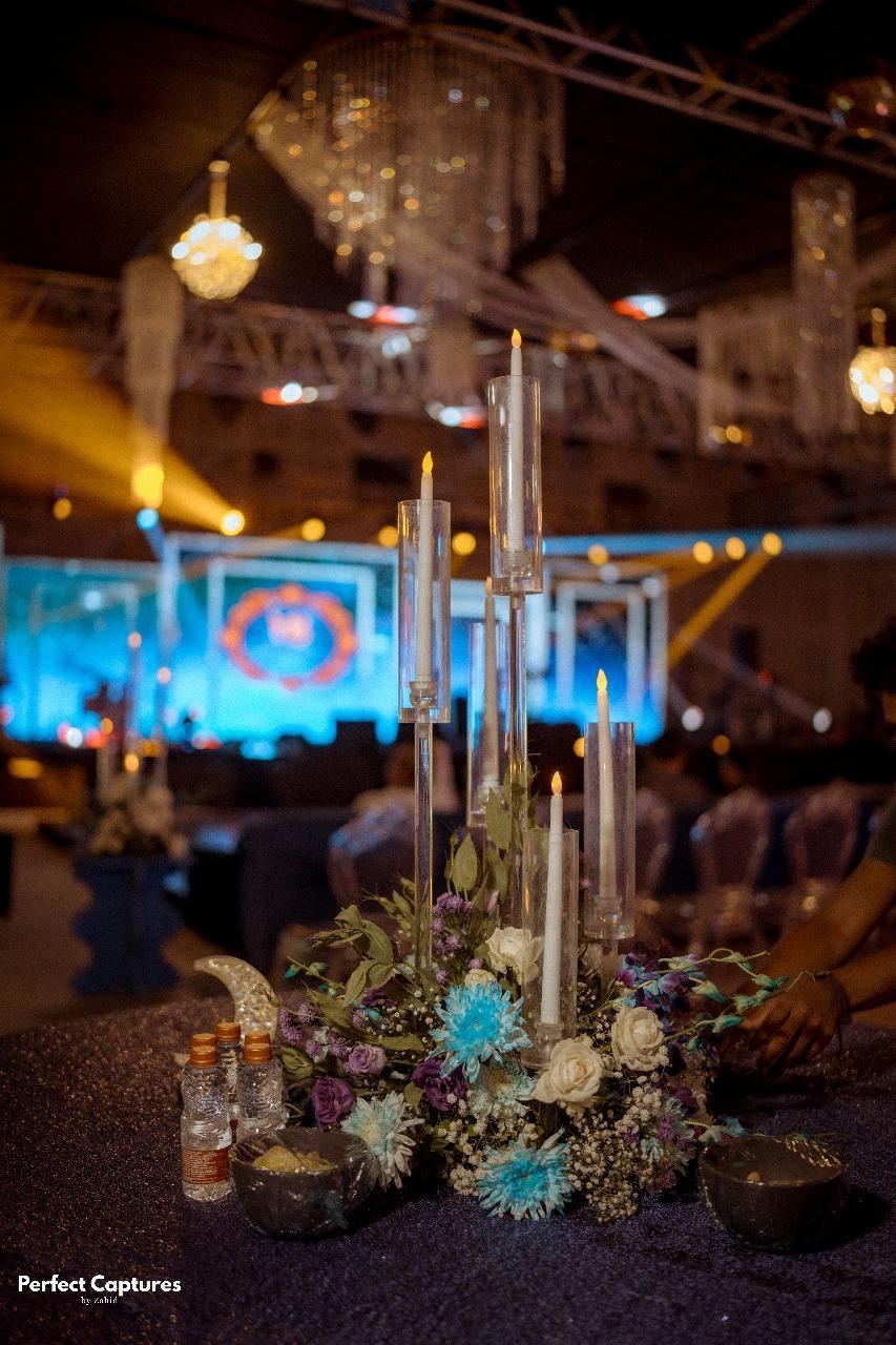 Crystal candelabra and dried floral centerpiece on a candlelit reception table