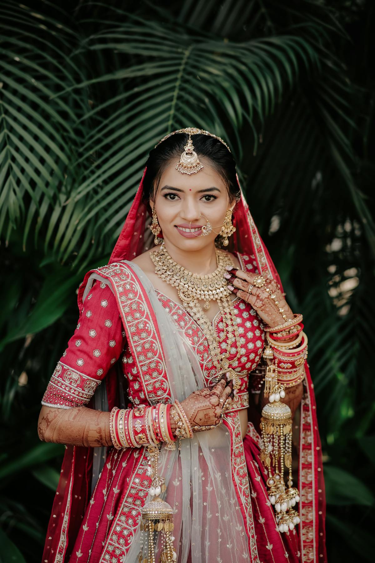 Indian bride in red bridal lehenga with gold jewellery — Panigrahana Weddings Bali