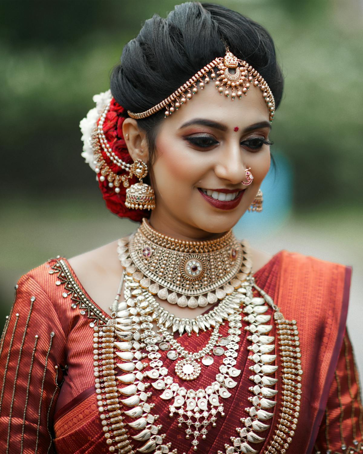 South Indian bride in red saree with elaborate gold jewellery — Panigrahana Weddings Sri Lanka