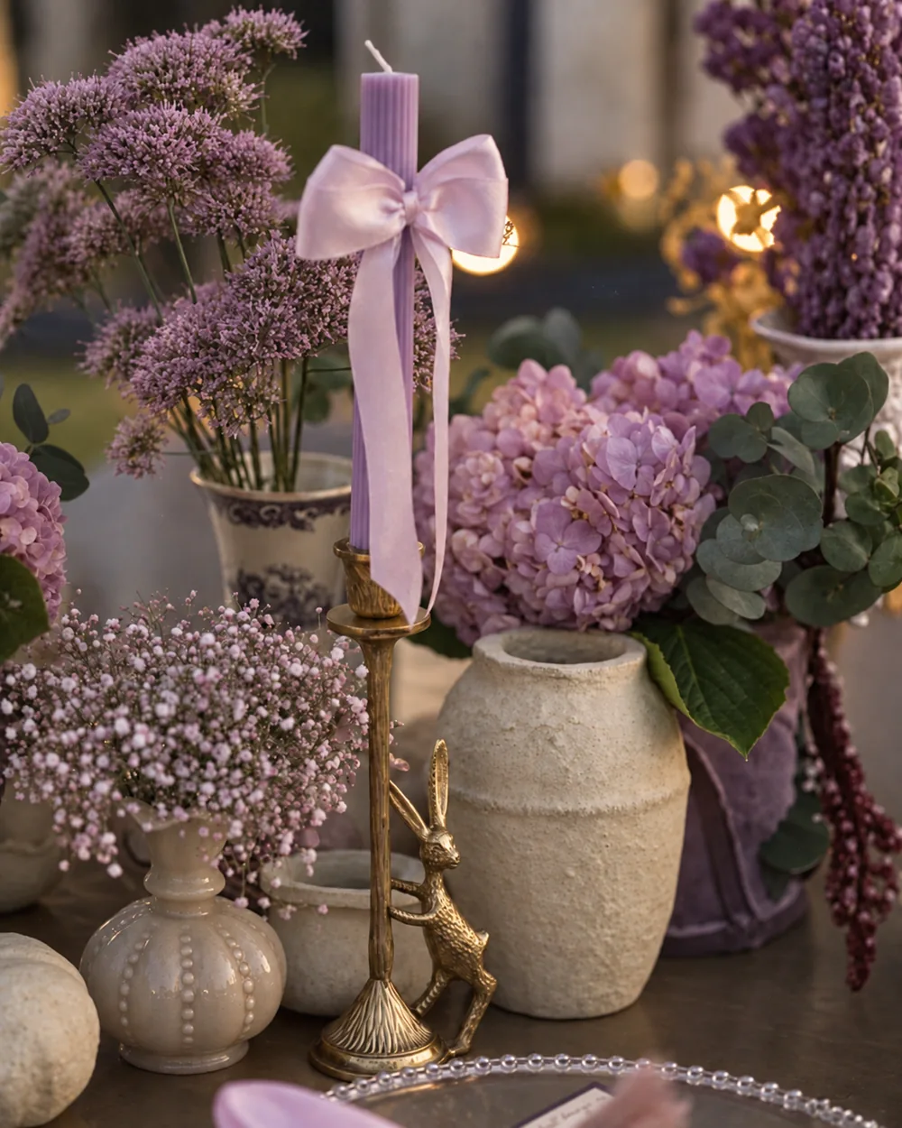 Lavender ribbon candle with a brass bird holder at Amitarasa, Bangalore. Decor execution by Panigrahana Weddings.