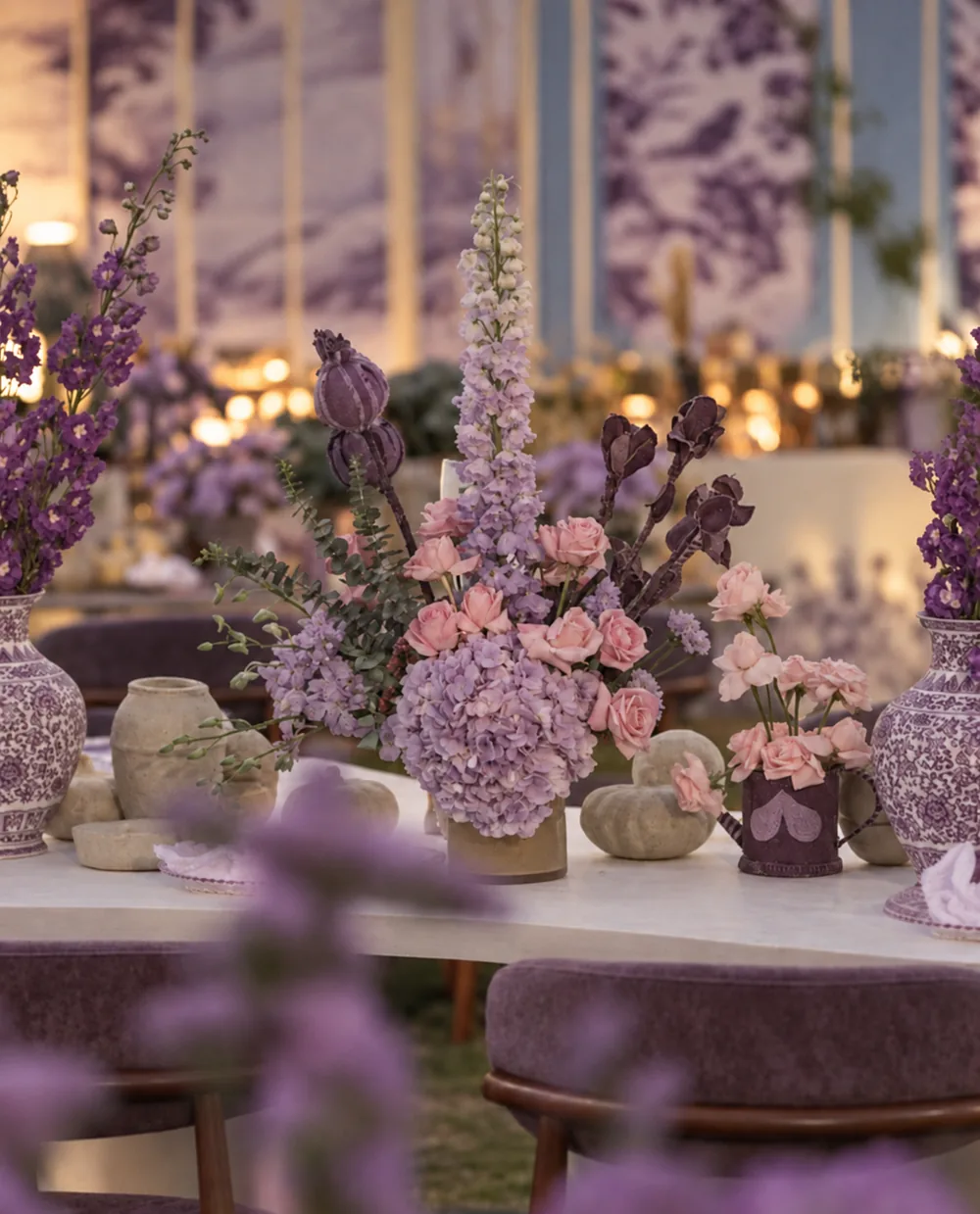 Pink and lavender table flowers in ceramic vessels at Amitarasa, Bangalore. Decor execution by Panigrahana Weddings.