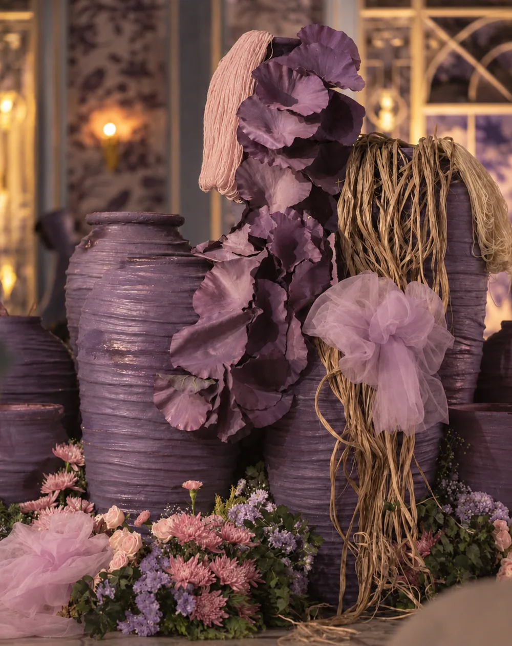 Textured purple vessels with fabric and trailing fibres at Amitarasa, Bangalore. Decor execution by Panigrahana Weddings.