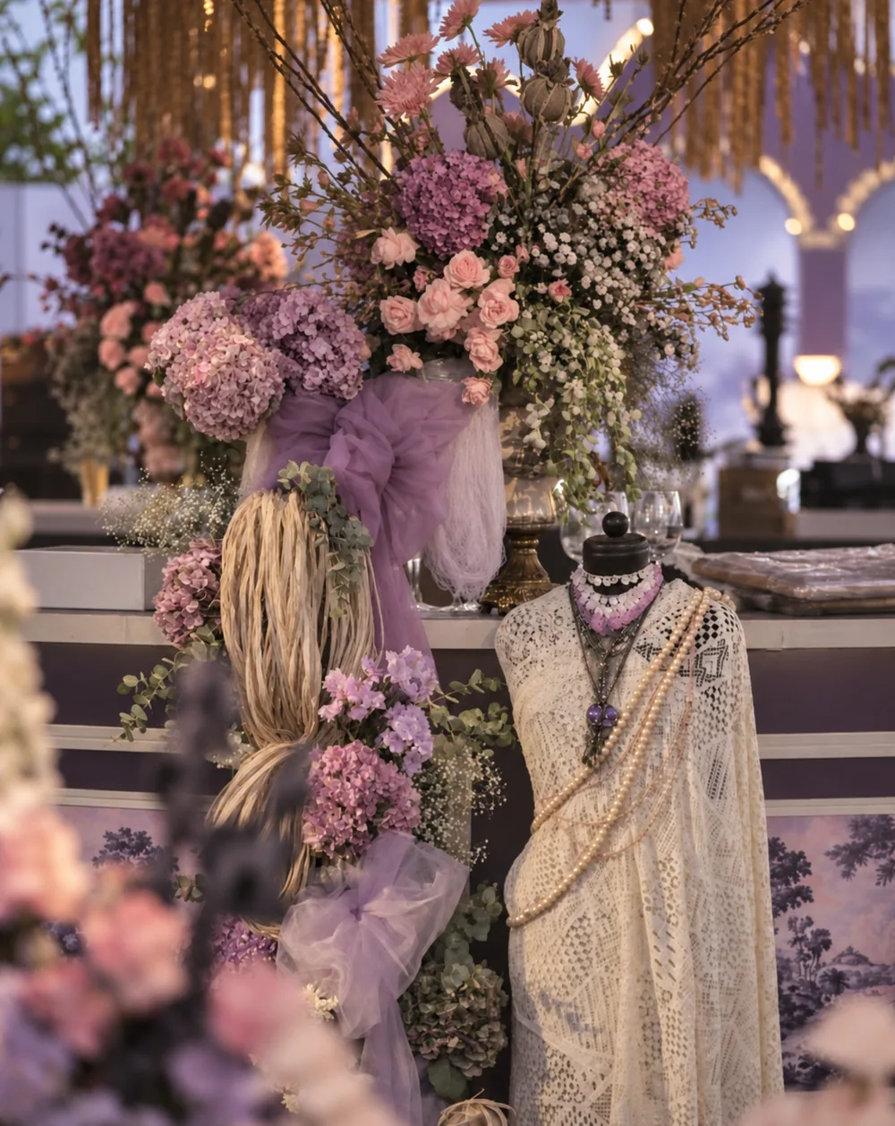 Floral arrangement beside a layered jewellery display at Amitarasa, Bangalore. Decor execution by Panigrahana Weddings.