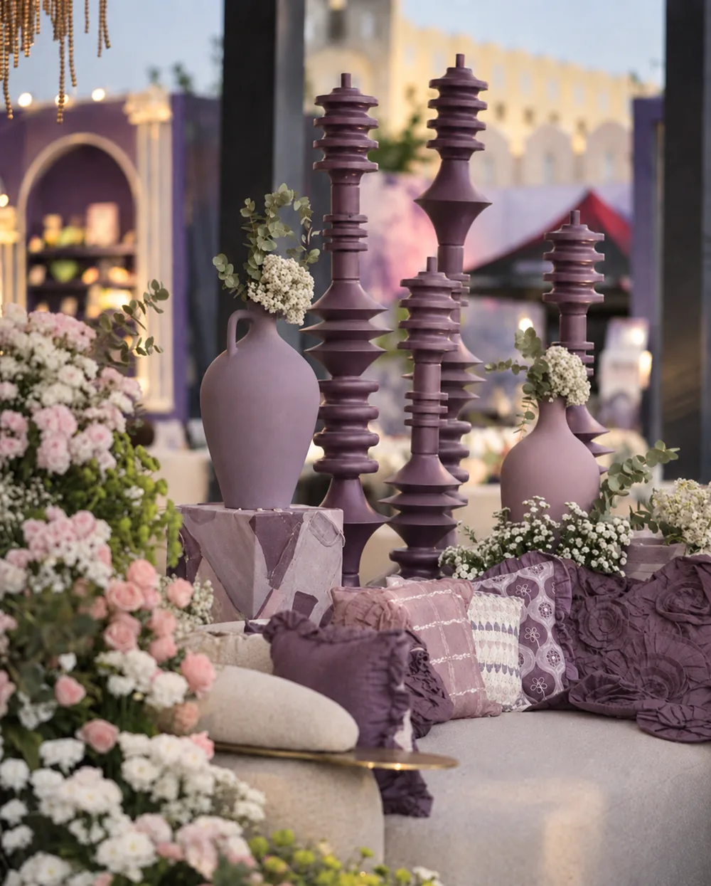 Cream lounge seating with mauve cushions and tall ornaments at Amitarasa, Bangalore. Decor execution by Panigrahana Weddings.