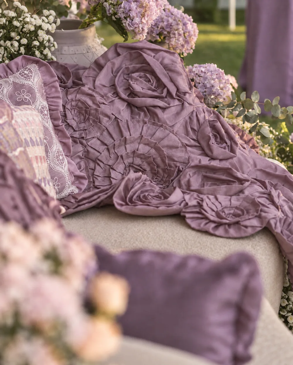 Mauve fabric rosettes and embroidered lounge cushions at Amitarasa, Bangalore. Decor execution by Panigrahana Weddings.