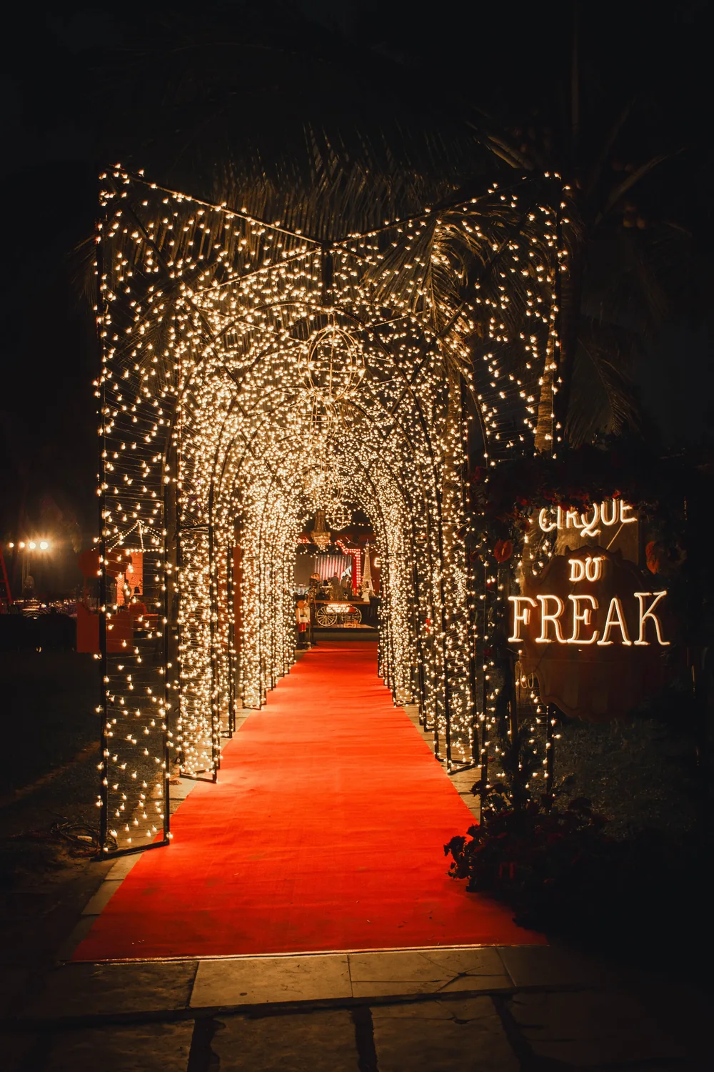 Fairy-light tunnel with red carpet at Caravela Beach Resort — Panigrahana decor portfolio