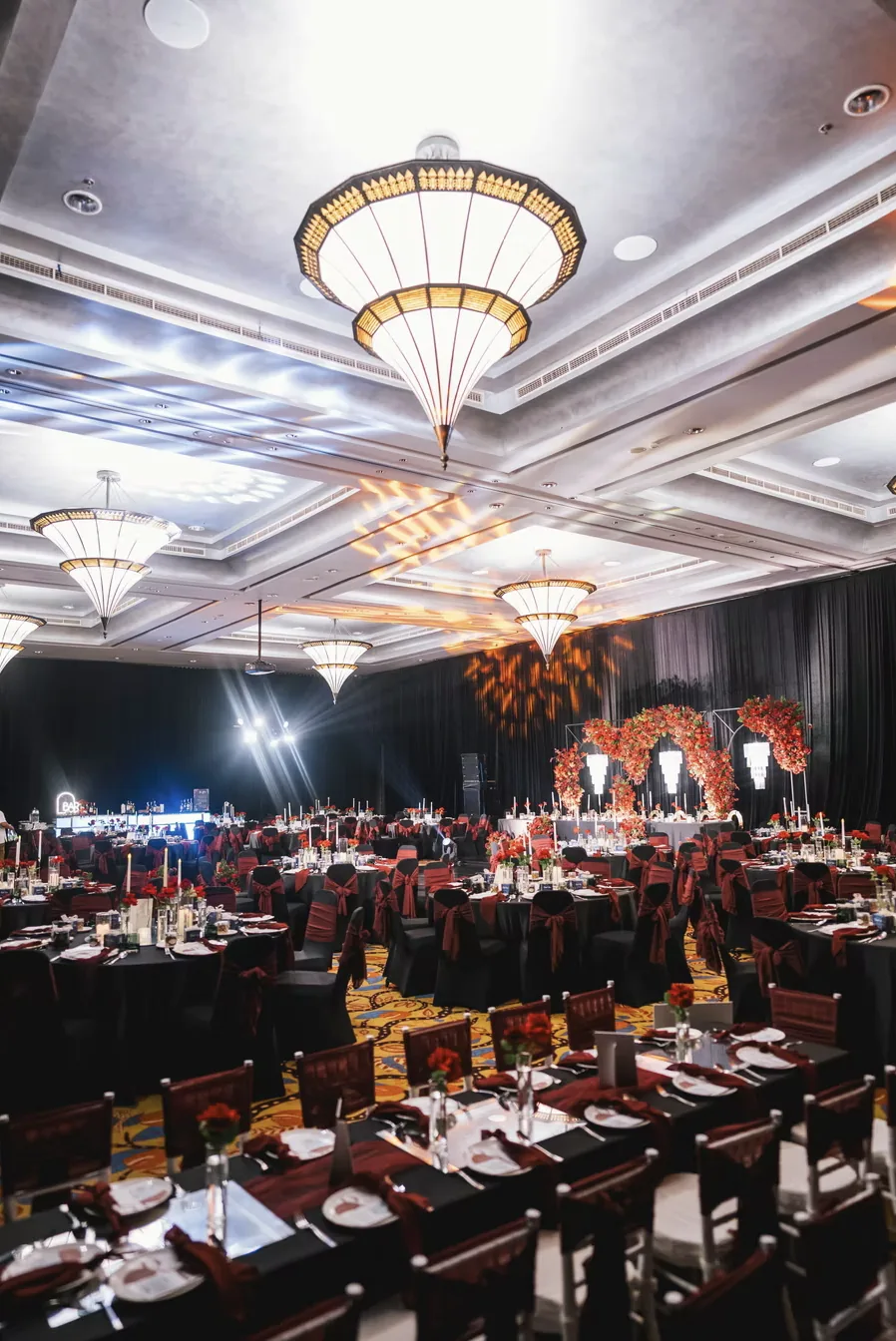 Ballroom tables beneath a chandelier at Conrad Bali — completed Panigrahana work