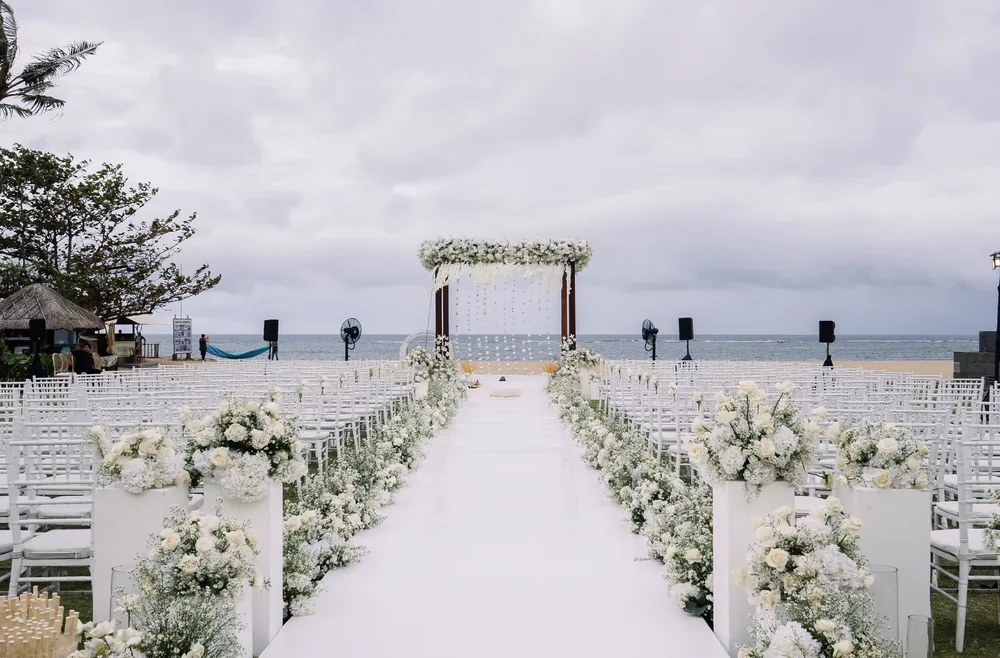 White floral aisle and oceanfront mandap at Conrad Bali — Panigrahana decor portfolio