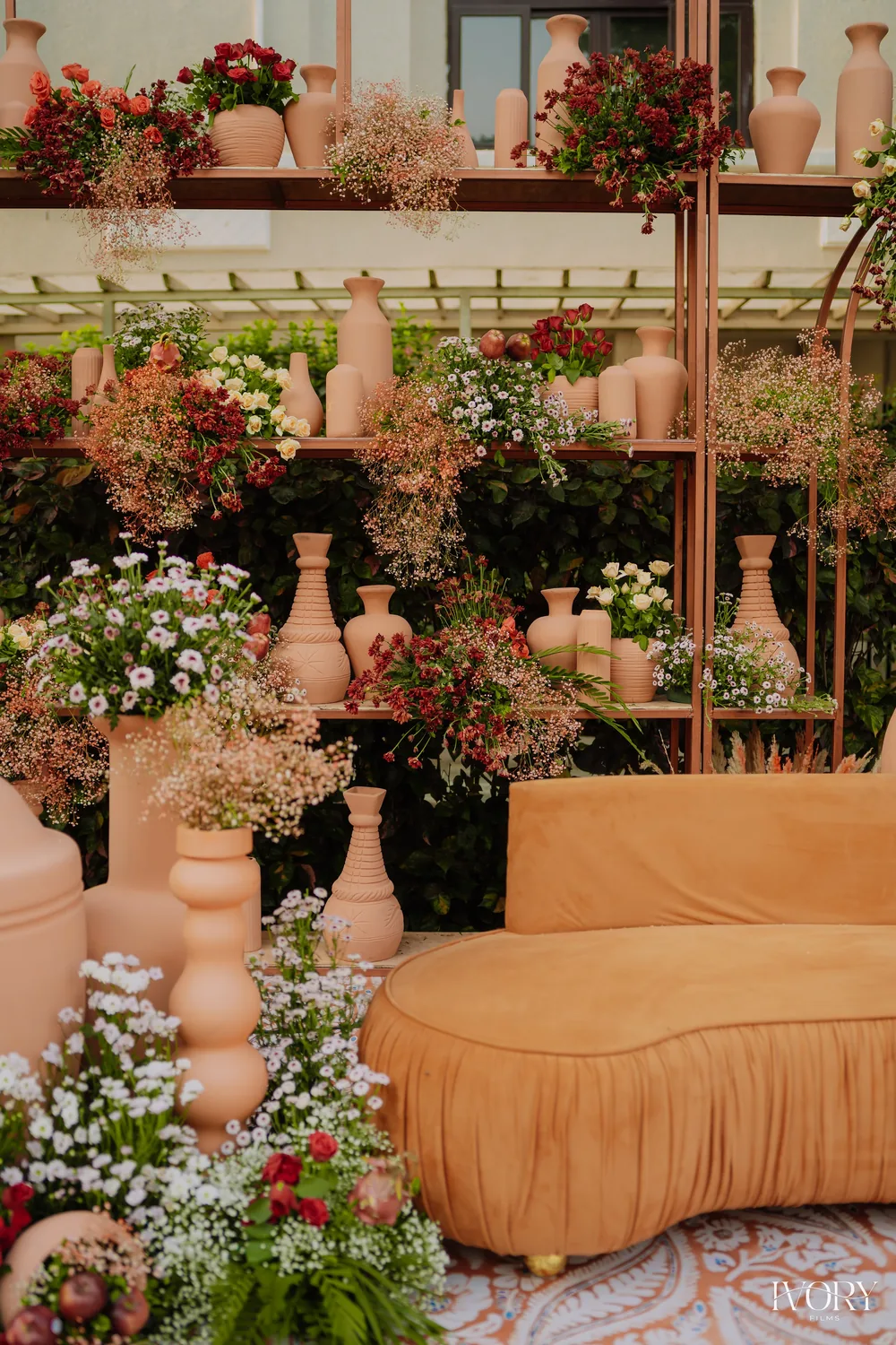 Floral mehendi backdrop with an ochre sofa — Panigrahana decor portfolio