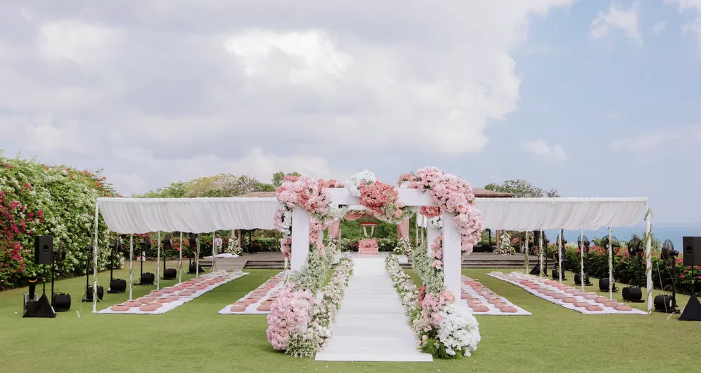 Pink floral mandap on the oceanfront lawn at Hilton Bali — Panigrahana decor portfolio