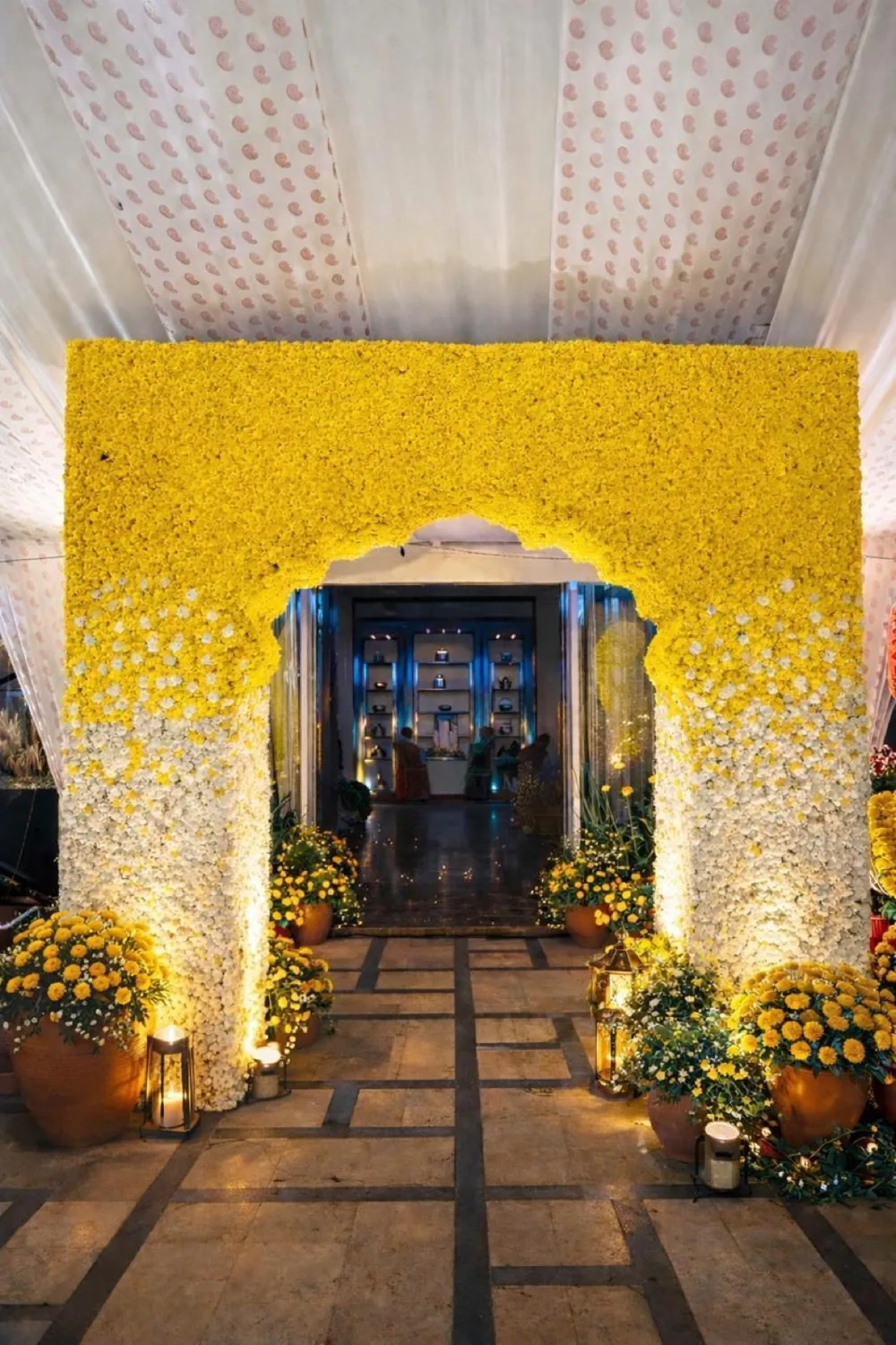 Yellow and white floral entrance arch — Panigrahana decor portfolio