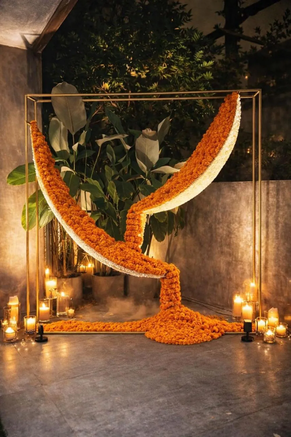 Curved marigold installation with candlelight — Panigrahana decor portfolio