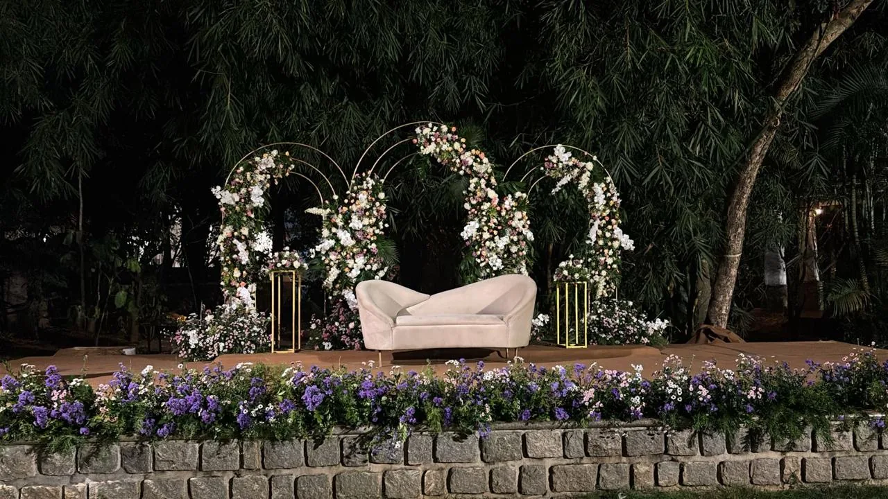 Floral arches behind a white chaise at Moongate