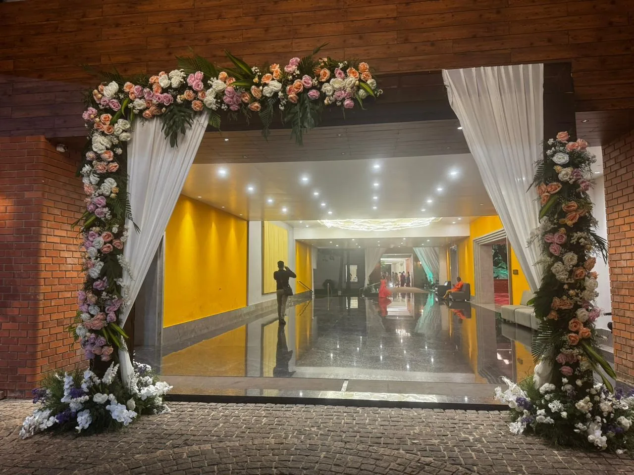 Floral doorway with white draping at Moongate
