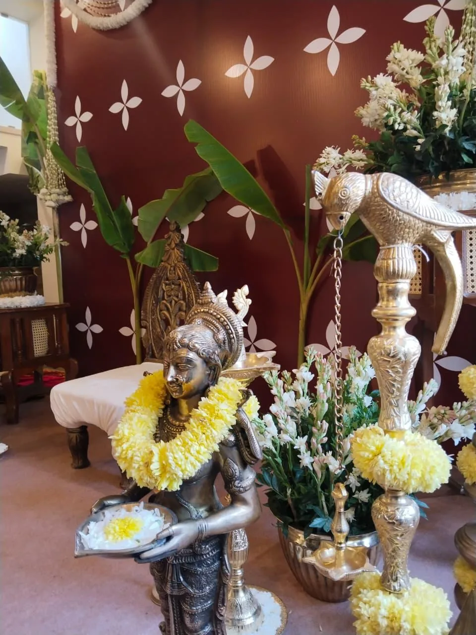 Brass lamps and flowers beside the ceremony at Moongate