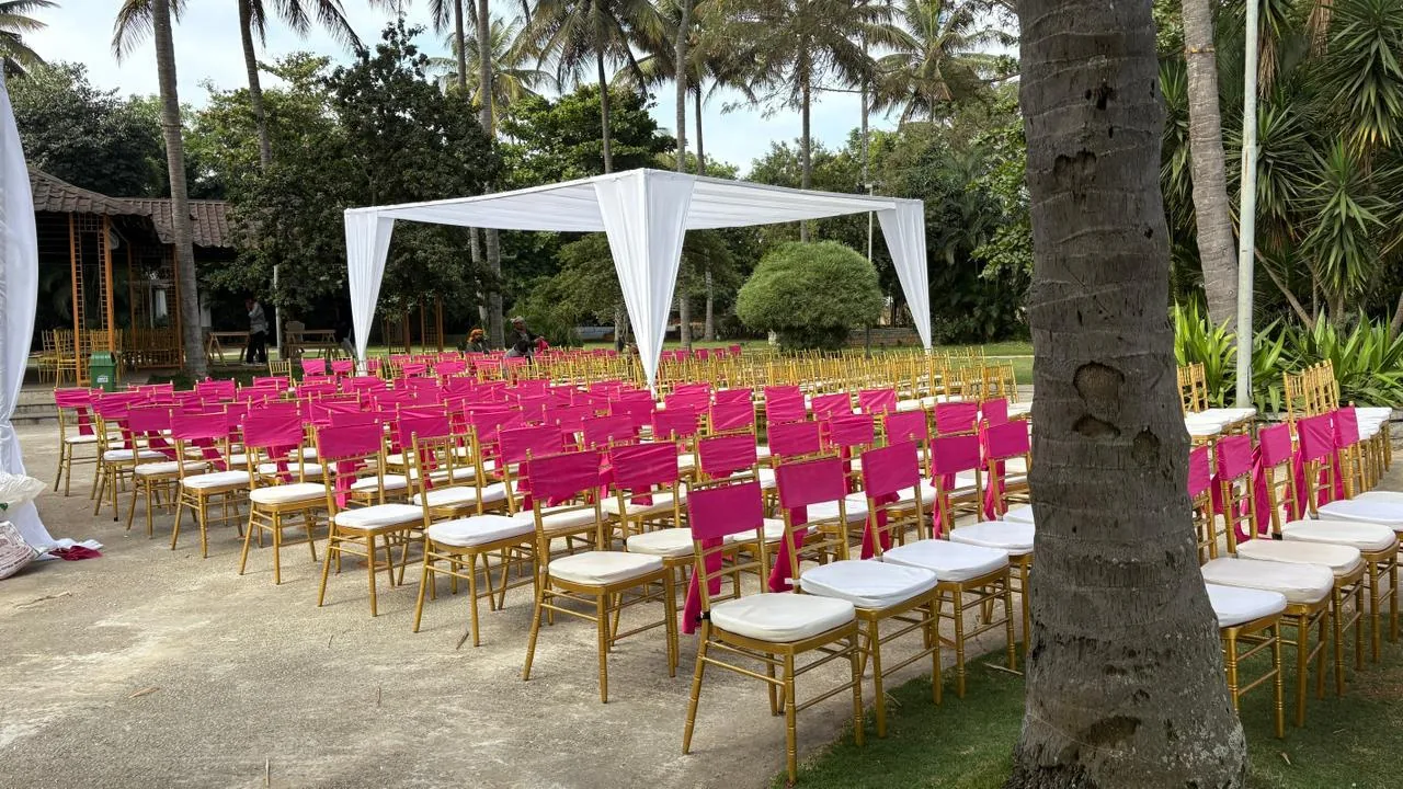 Pink and gold chairs beneath white canopies at Moongate