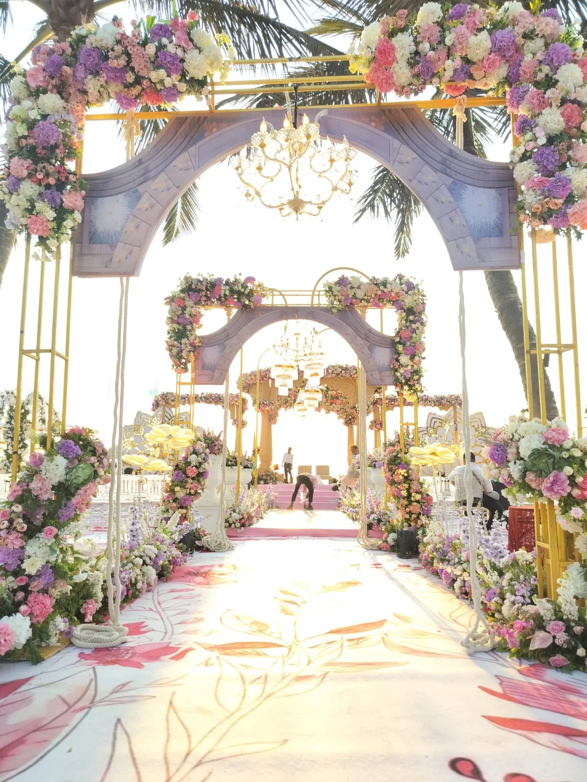 Floral ceremony aisle beneath the palms at The St. Regis Goa Resort
