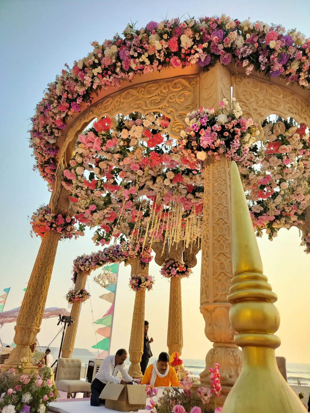 Flowers and brass bells beneath the mandap canopy at The St. Regis Goa Resort