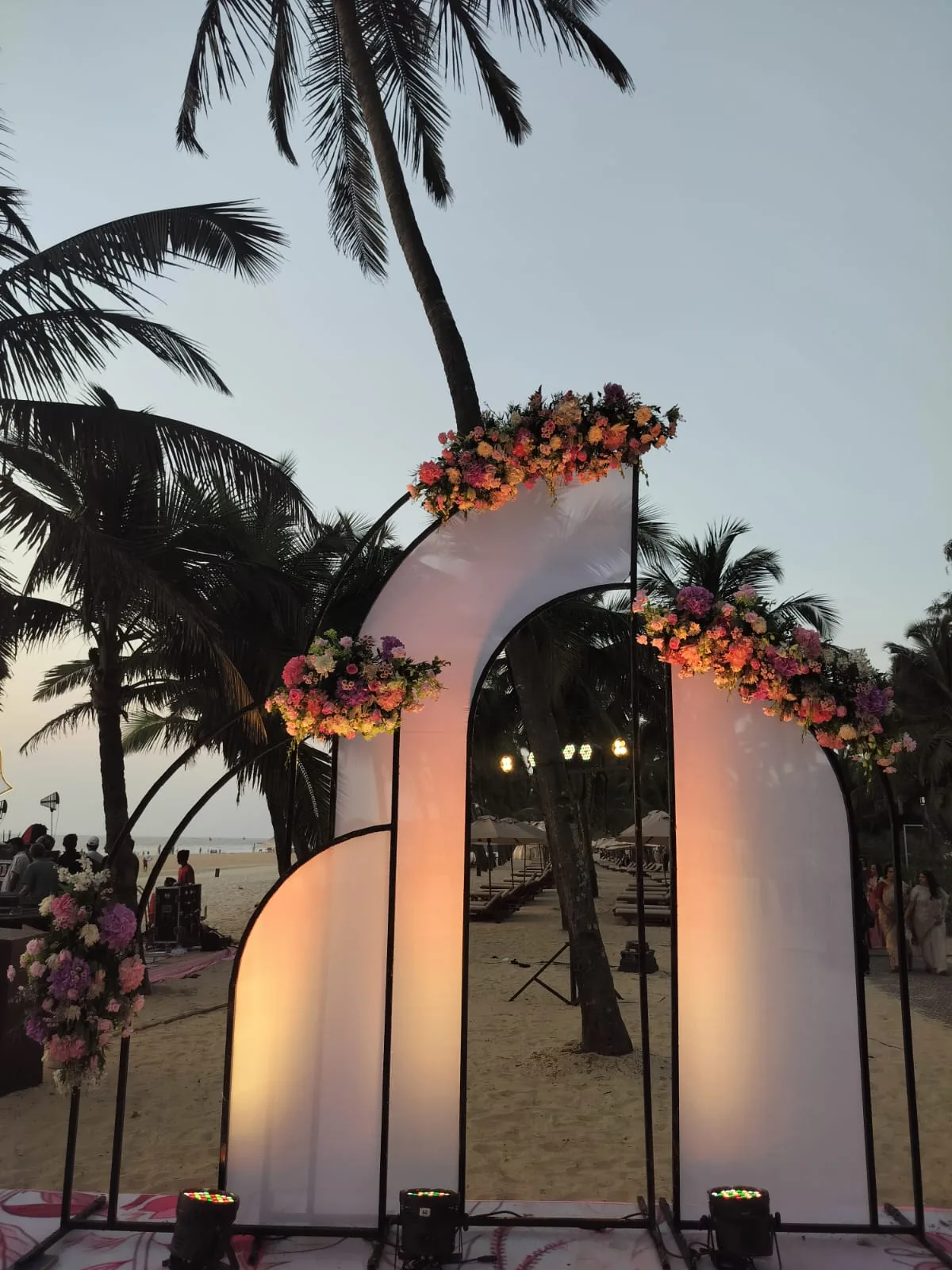 Illuminated floral entrance arch at dusk at The St. Regis Goa Resort