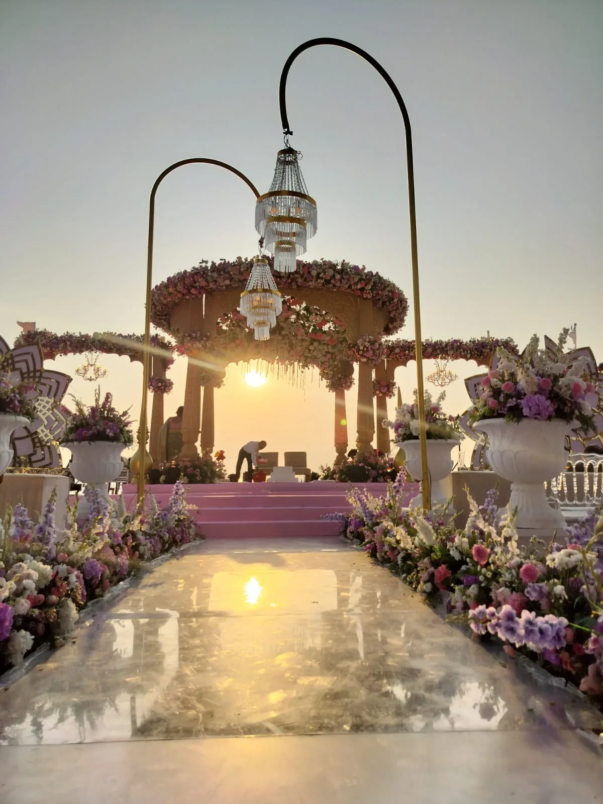 Lantern-lined aisle toward the sunset mandap at The St. Regis Goa Resort