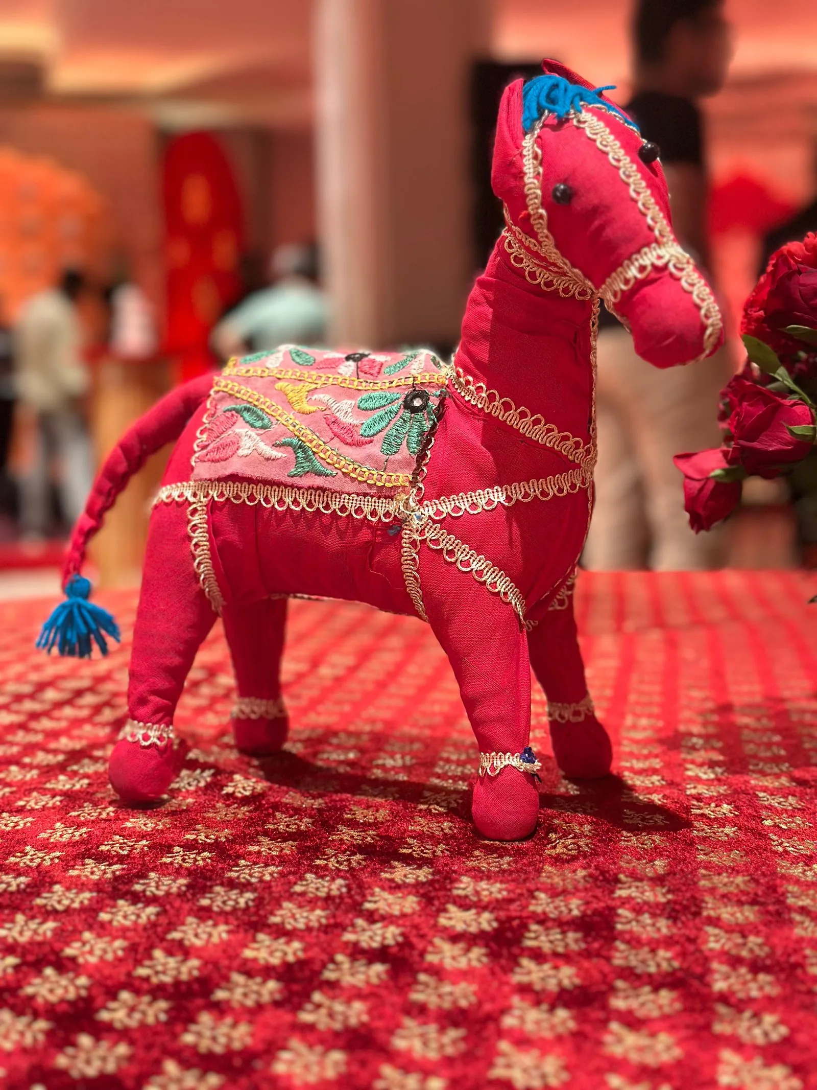 Pink decorative horse on patterned table linen at The St. Regis Goa Resort