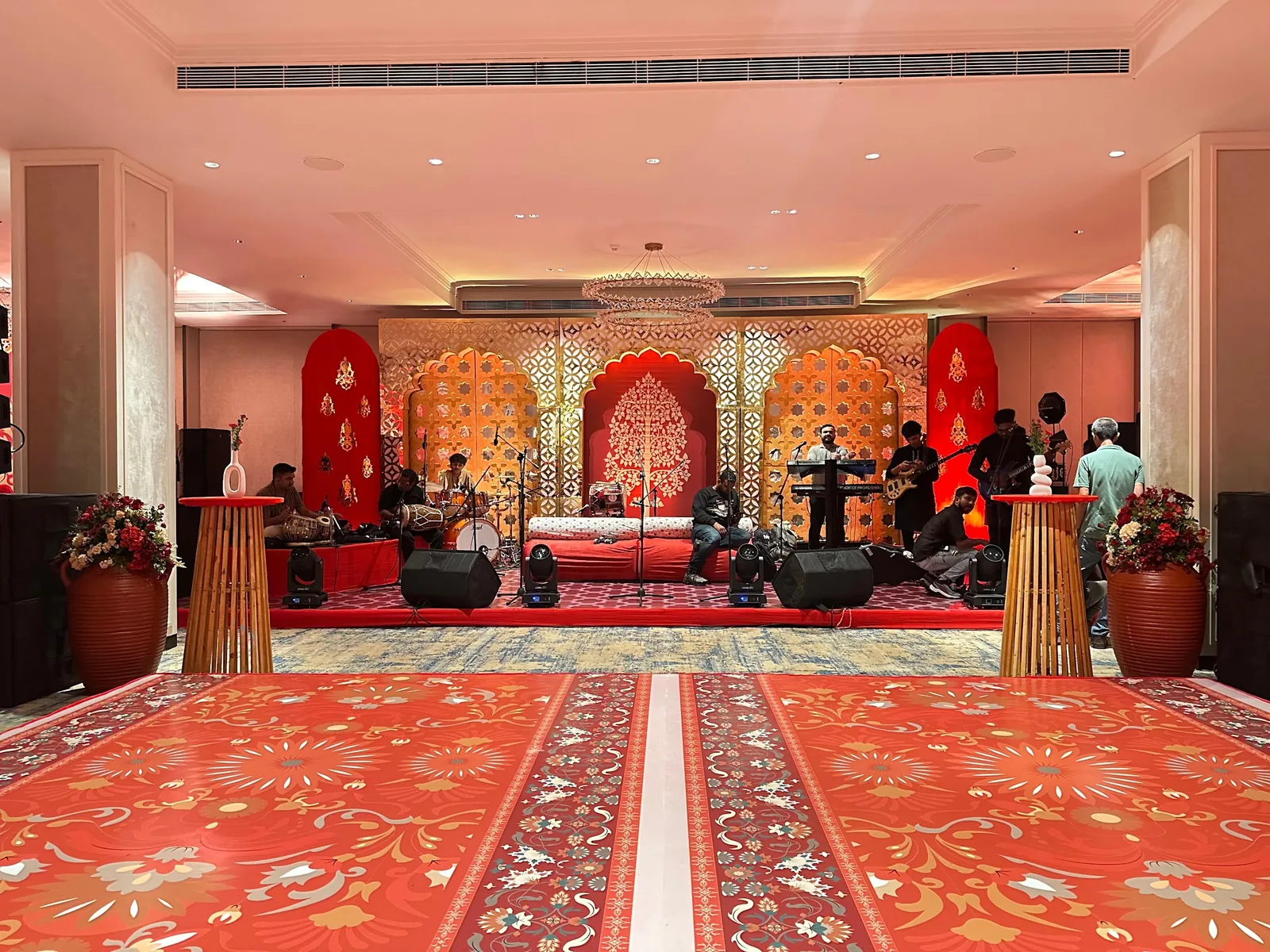 Red and gold stage with a patterned dance floor at The St. Regis Goa Resort