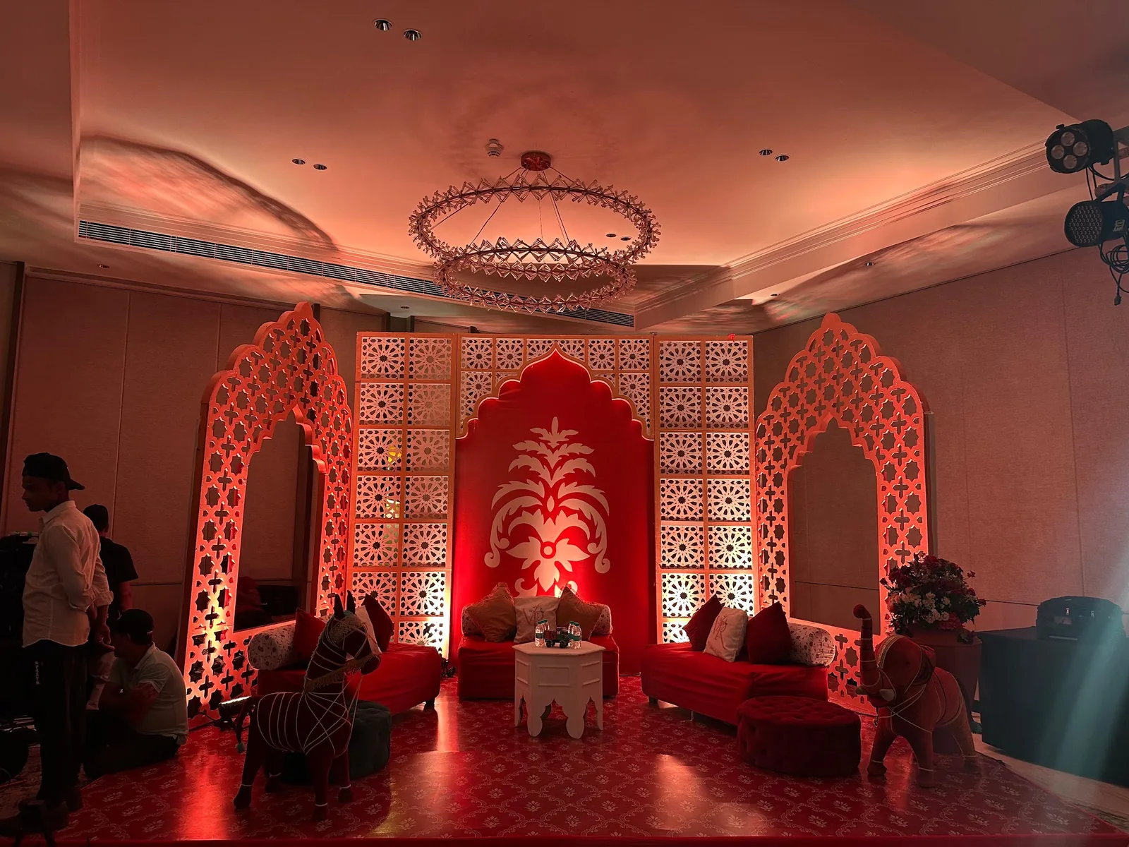 Red lounge framed by patterned arch panels at The St. Regis Goa Resort