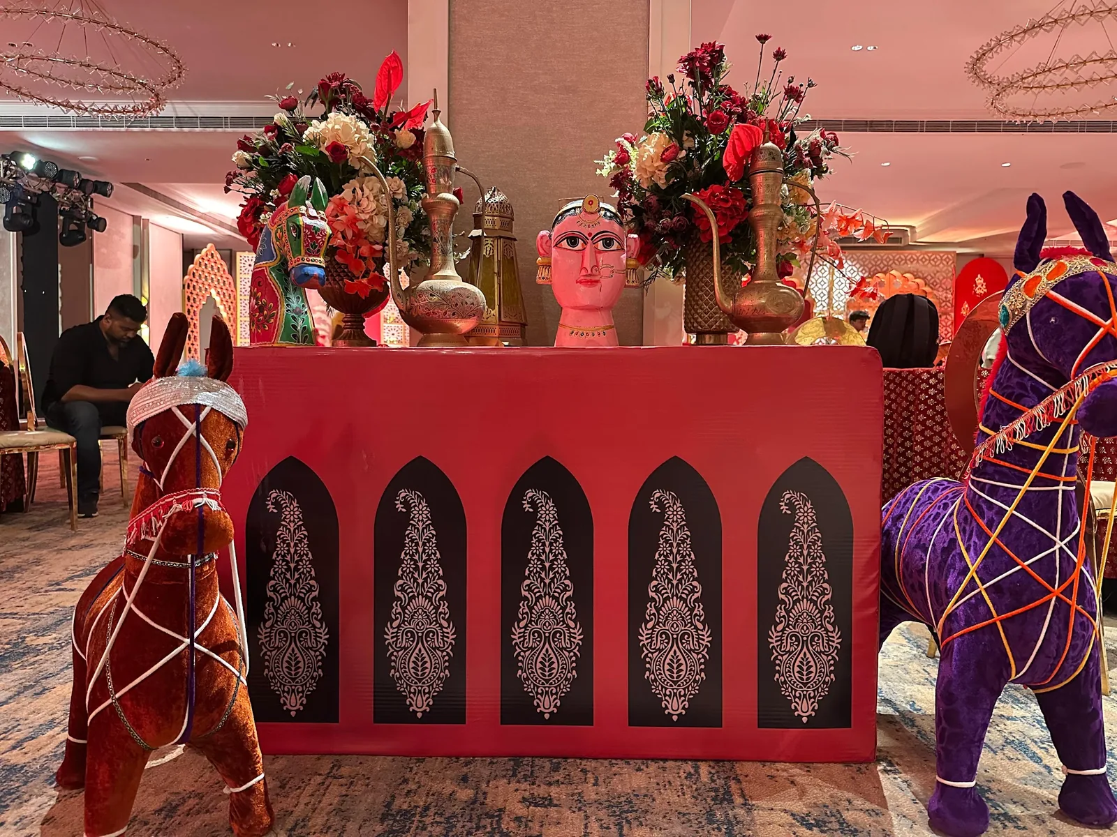 Red patterned counter with decorative horse figures at The St. Regis Goa Resort