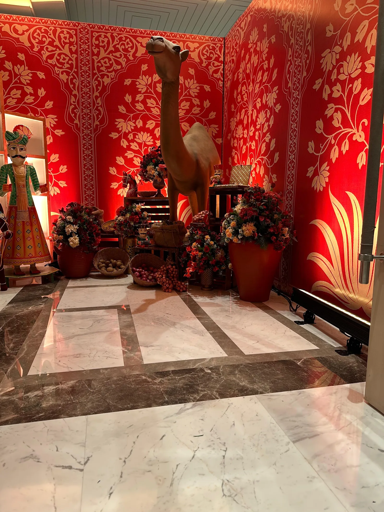 Red patterned panels and camel installation at The St. Regis Goa Resort