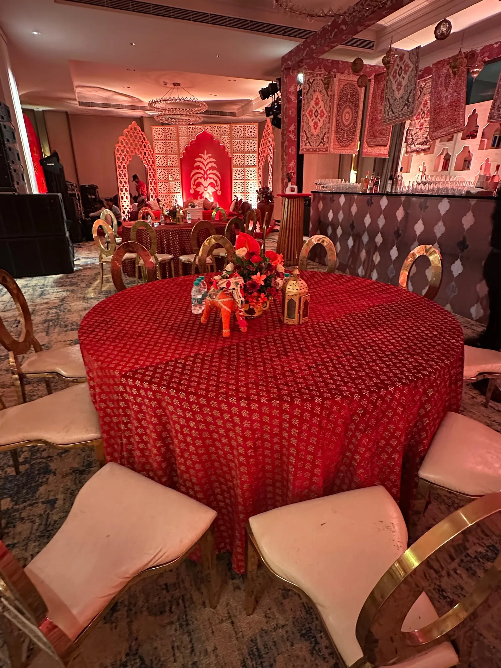 Round guest table with red linen and floral centrepiece at The St. Regis Goa Resort