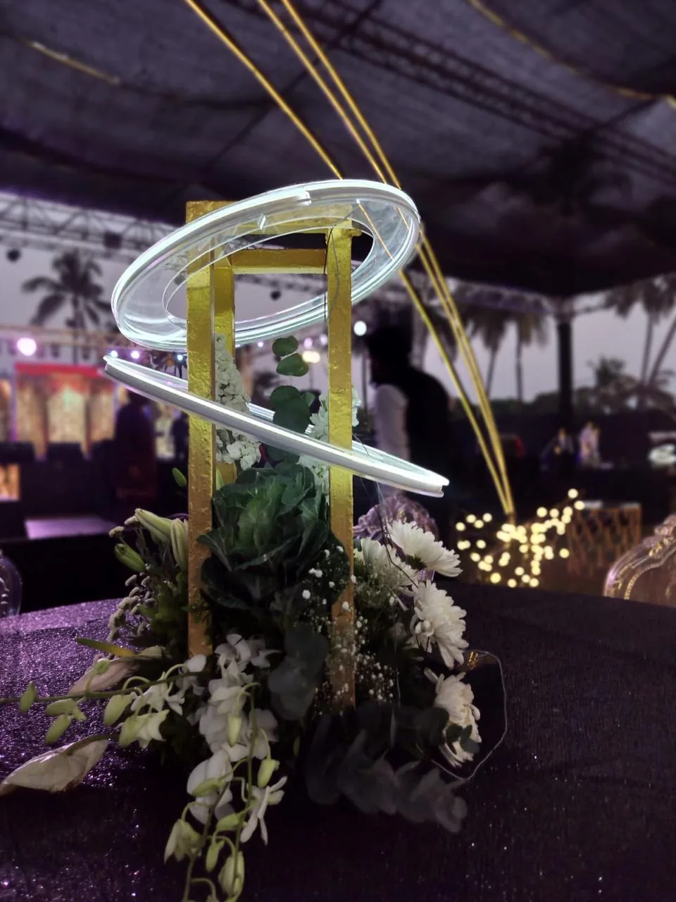 White illuminated loops around a floral pedestal at The St. Regis Goa Resort