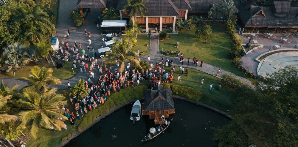 Aerial view of guests around the waterside ceremony pavilion at The Zuri Kumarakom