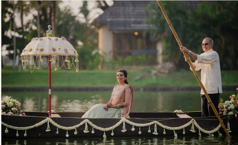 Bridal boat arrival beneath a floral parasol at The Zuri Kumarakom