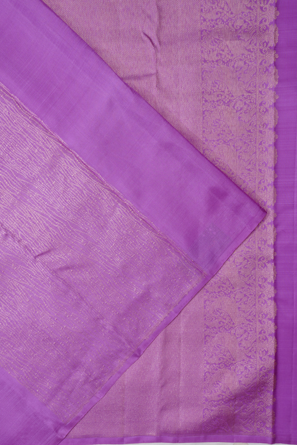 Lavender Kanchipuram silk brocade saree with antique zari, laid flat to show the body and border