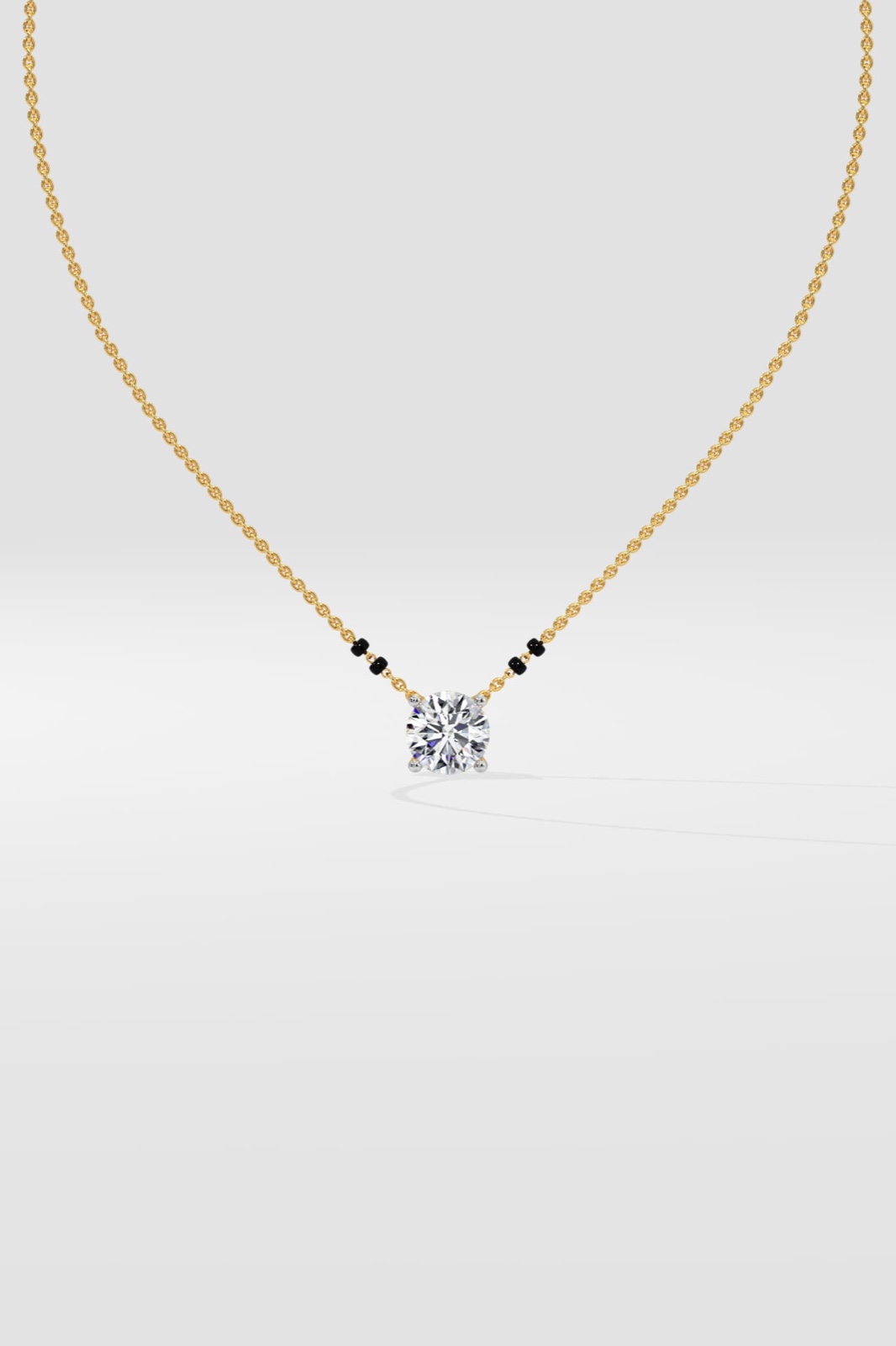 Round solitaire lab-grown diamond on a fine yellow-gold mangalsutra chain with black beads