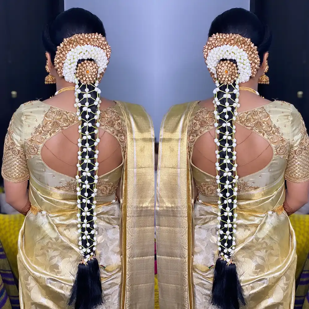 Back view, shown twice, of a bridal bun ringed with jasmine and gold pieces above a long braid netted with jasmine, with a gold silk saree