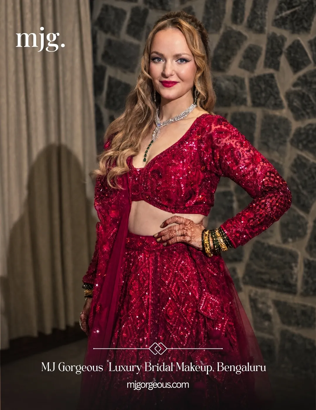 Bride in a red sequinned reception lehenga with a red lip, defined eyes and loose waves