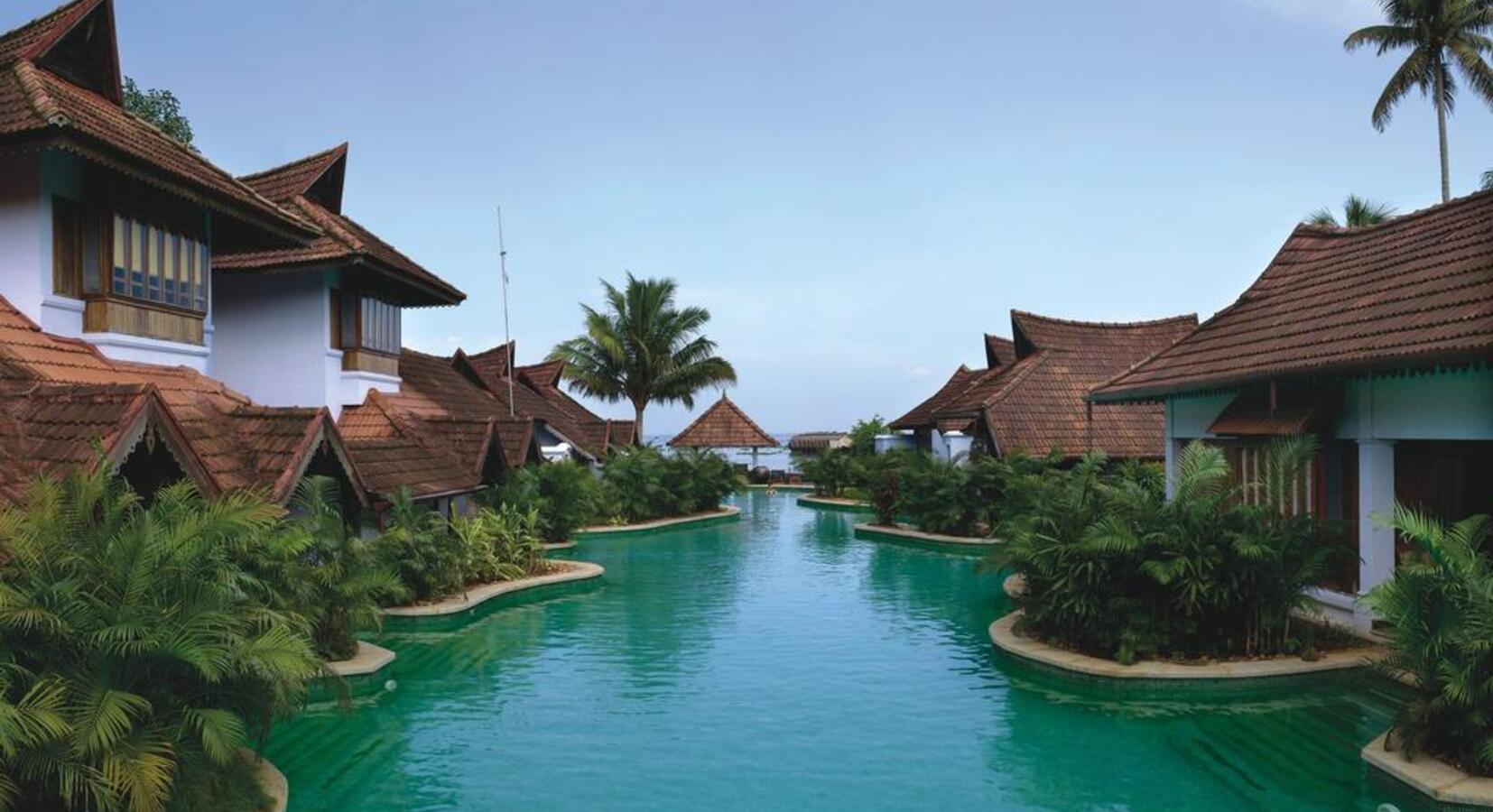 Villas beside the swimming pool at Kumarakom Lake Resort