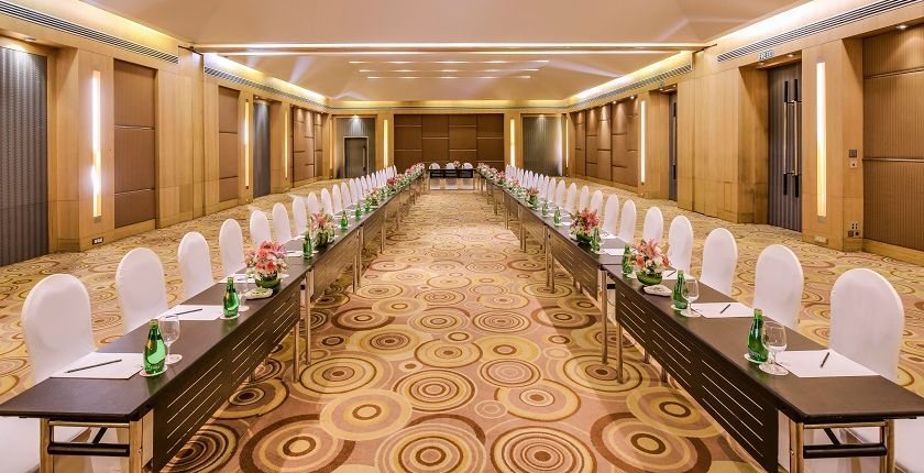 Lalit 3 & 4 at The LaLiT Ashok Bangalore laid as a single long table running the length of the room on patterned carpet