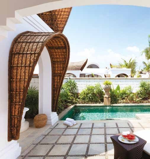 Private plunge pool at a Taj Bekal villa with the curved bamboo canopy rising over the terrace and paved decking alongside