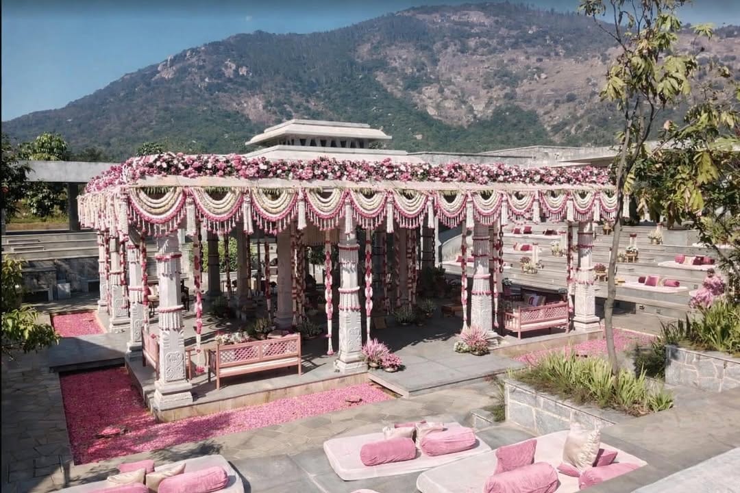 Pink and white floral mandap with pearl garland swags and mountain views at Amita Rasa, Nandi Foothills