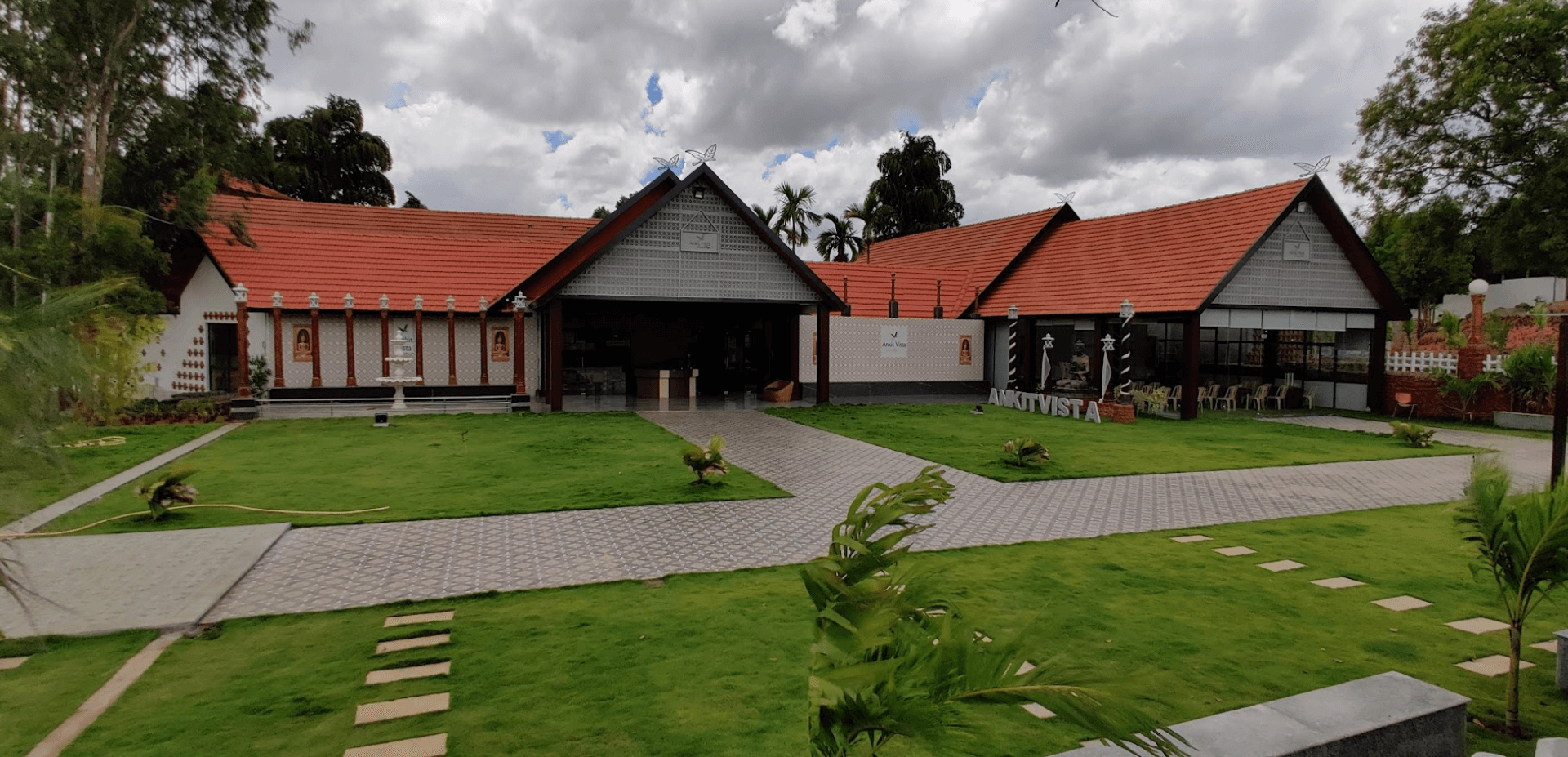 Ankit Vista Green Village resort buildings and landscaped lawn in Nelamangala