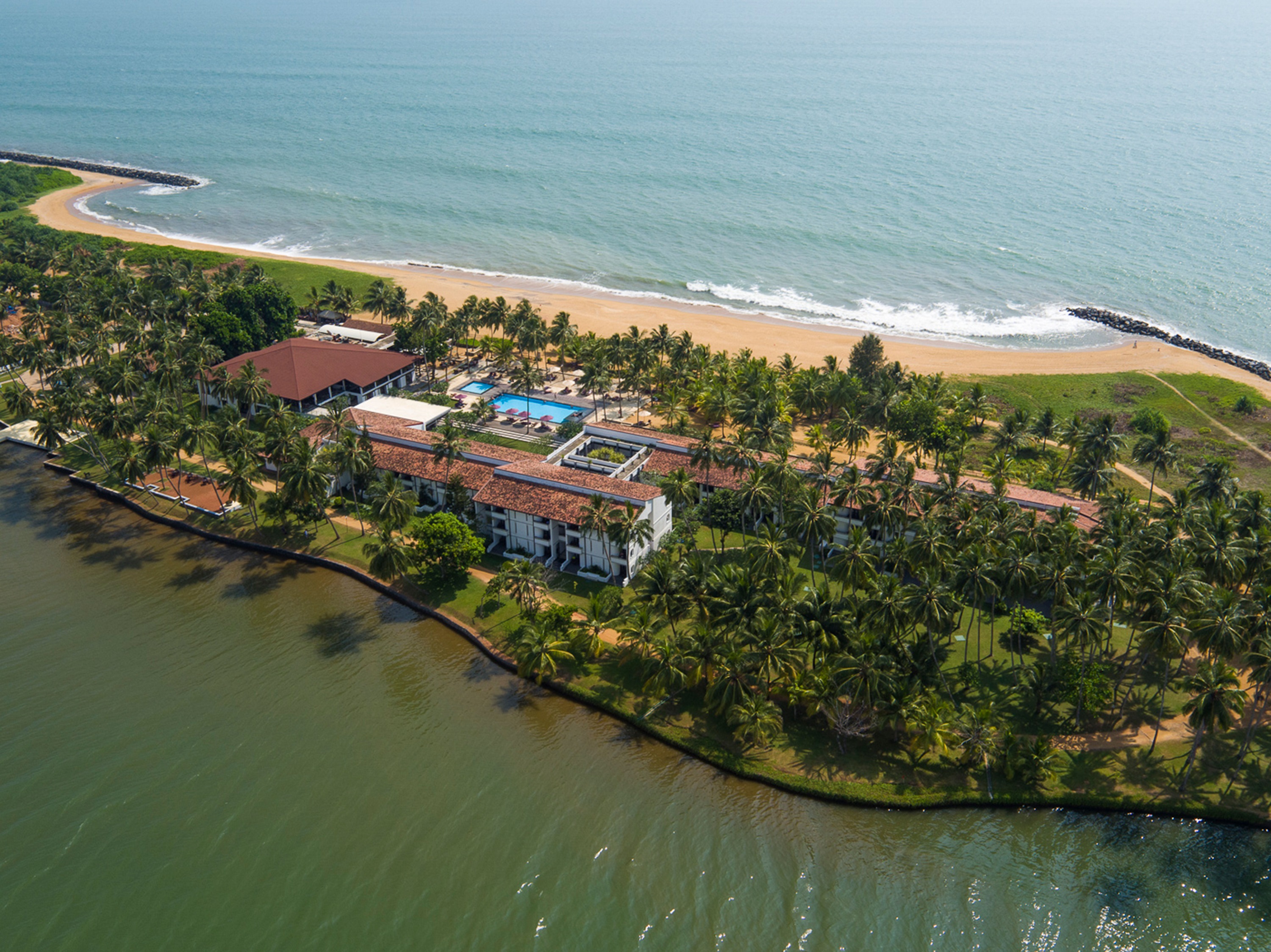 Aerial view of Avani Kalutara Resort between river and beach
