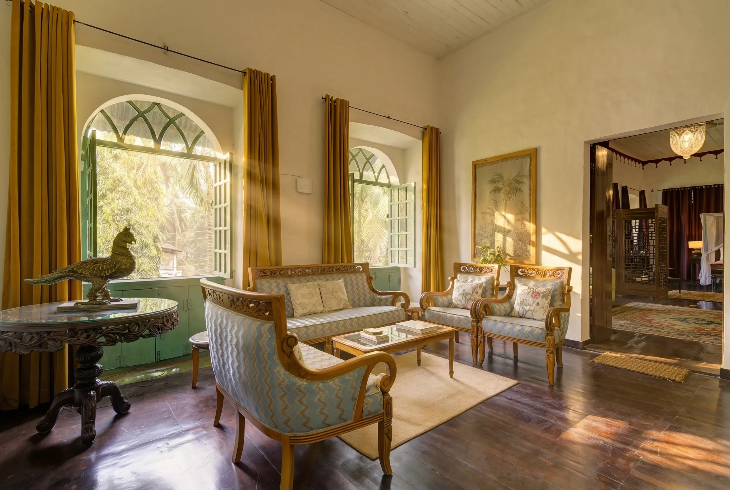 Antique furniture and arched windows inside Siolim House in Goa