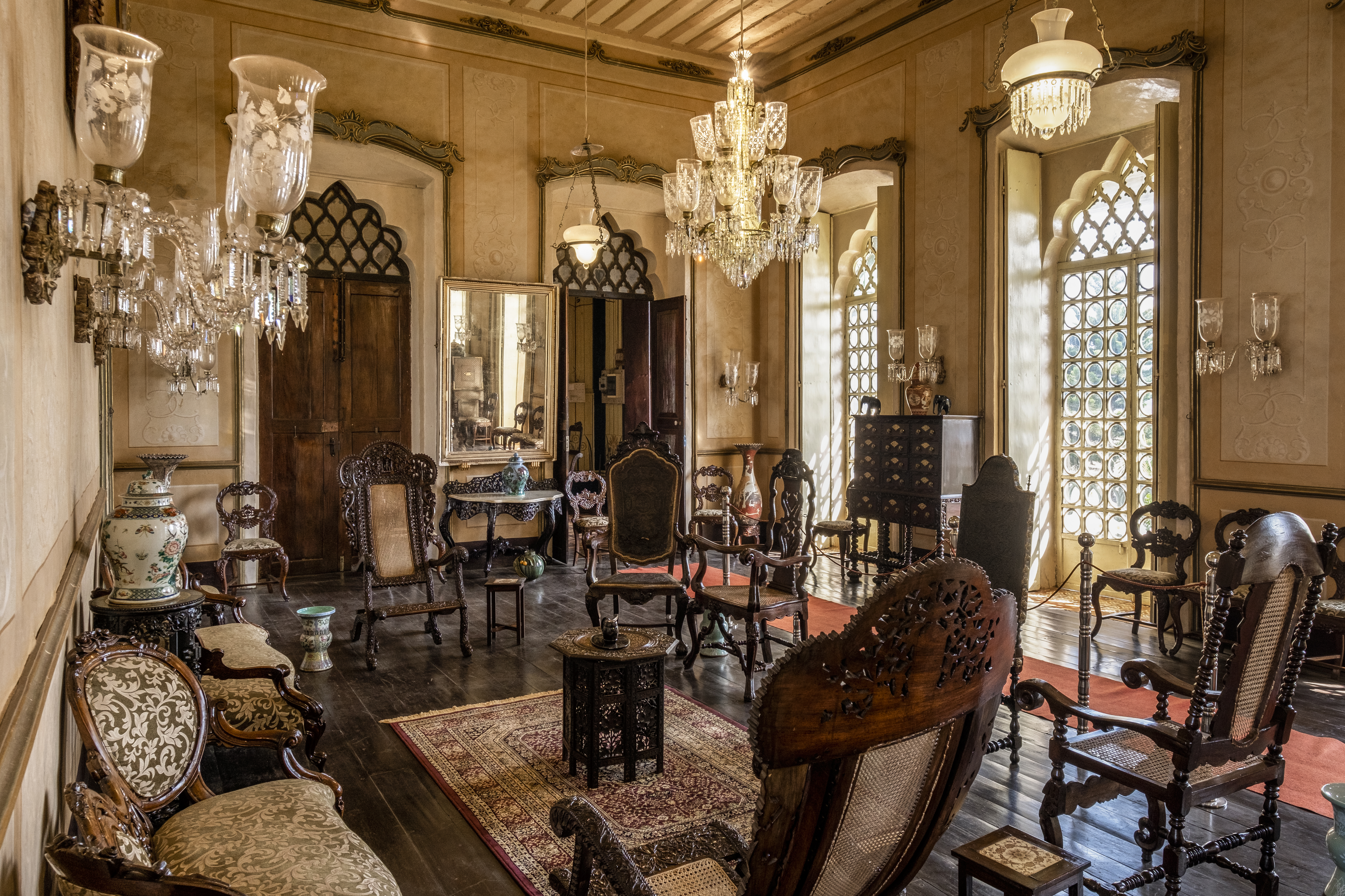 Historic interior with chandeliers and antique furniture in Figueiredo House, Goa