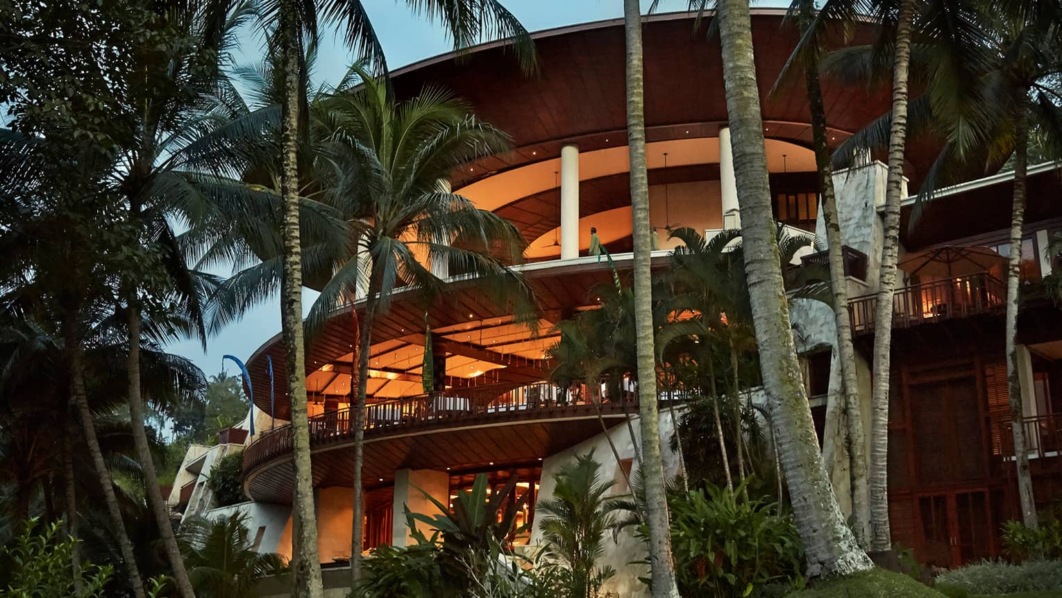Curved balconies of Four Seasons Resort Bali at Sayan at dusk